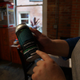 Shannon Mohr showing off the goods. The beer cans include information on the lake’s algae blooms.